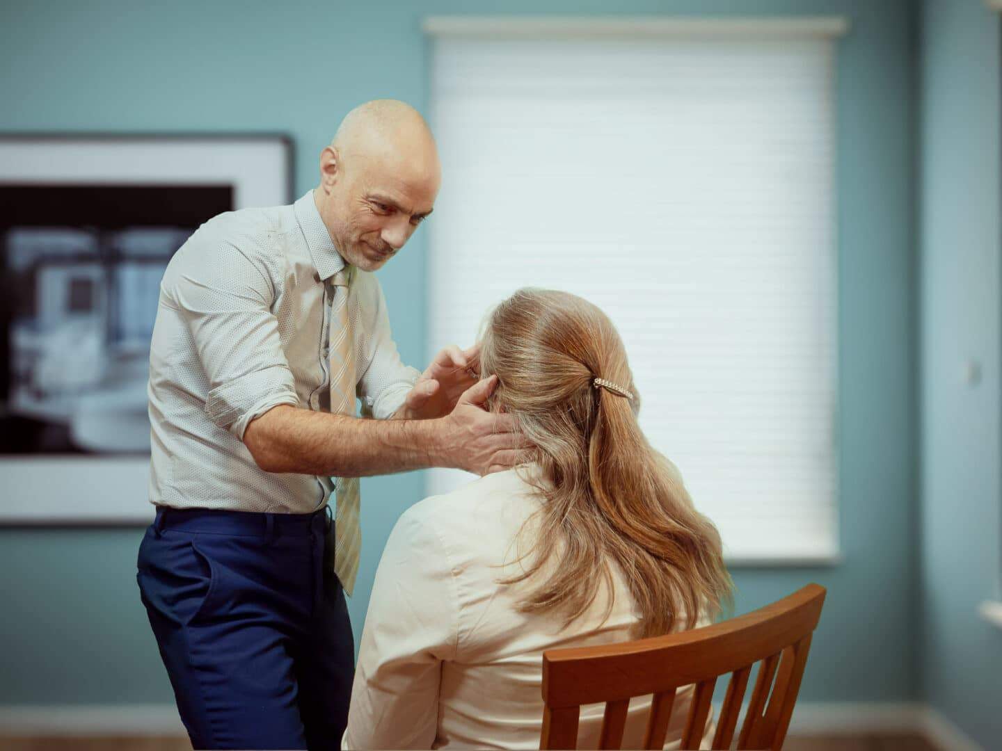 Surgeon Alex Ramsden examining female temporal migraine patient